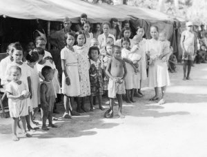 HERSHEY BAR DIPLOMACY - The native line up for snacks from Lt. Al and his pals. Papua New Guinea 1944