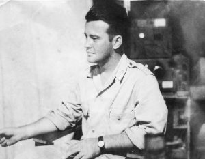 Lt. Al in the Radio Room listening to the ball scores.