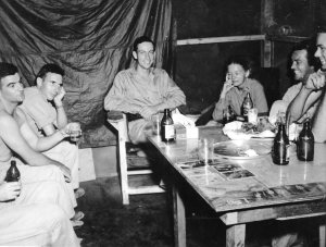 BEER DELIVERY MAKES FOR HAPPY SOLDIERS. Lt. Al and his signal Corps buddies enjoying a few.