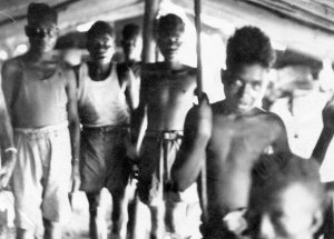 Papuan native vist Lt. Al's tent. This was the first time their picture had been taken. New Guinea 1944