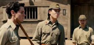 Jack O'Connell as the intrepid Louie Zamperini, shown here with his tormentor